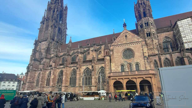 Fotografia da Catedral de Freiburg e do mercado à sua frente